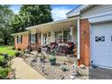 Cozy front porch with decorative accents, potted plants, and seating, leading to a charming brick home at 2608 E 500 N, Whiteland, IN 46184