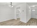 Bright living room with neutral walls, wood-look flooring, and an open layout into the kitchen at 2642 Country Estates Dr, Indianapolis, IN 46227
