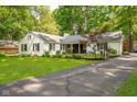 Beautiful home with a well-kept lawn and an asphalt driveway leading up to the front of the house at 3312 W 42Nd St, Indianapolis, IN 46228