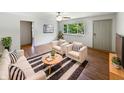 Bright living room with hardwood floors, modern furniture, and a large window offering scenic views at 3344 Southwest Dr, Indianapolis, IN 46241