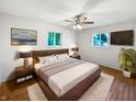 Comfortable main bedroom with a ceiling fan, hardwood floors, and two windows for natural light at 3344 Southwest Dr, Indianapolis, IN 46241