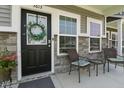 Close-up of cozy porch with seating, decorative wreath, and stone accents on home's facade at 3613 Lehigh Ave, Westfield, IN 46074