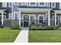 Inviting front porch featuring stylish chairs and lush landscaping in front of the townhome at 3613 Lehigh Ave, Westfield, IN 46074