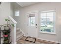 Bright entryway featuring a staircase, a front door with sidelight, and a large window for natural light at 3643 Thomas Jefferson St, Westfield, IN 46074