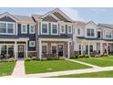 Attractive townhome exteriors with lush lawns, stone details, and cozy porches, creating a welcoming community at 3643 Thomas Jefferson St, Westfield, IN 46074
