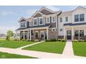 Charming townhome exteriors with stone accents, pristine lawns, and inviting walkways in a serene neighborhood at 3643 Thomas Jefferson St, Westfield, IN 46074