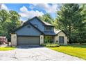 Charming home with a well-maintained lawn, a vibrant green door, and beautiful landscaping at 3715 Pitkin Rd, Martinsville, IN 46151