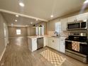 Modern kitchen featuring stainless steel appliances, white cabinets, and an island with counter seating at 3835 N Kenwood Ave, Indianapolis, IN 46208