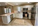 Updated kitchen featuring stainless steel appliances, quartz countertops, and ample cabinet space at 3835 N Kenwood Ave, Indianapolis, IN 46208