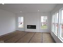 Bright living room with recessed lighting, a modern fireplace, and large windows offering plenty of natural light at 3993 Bozeman Way, Bargersville, IN 46106