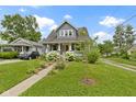 Inviting two-story home features a landscaped front yard, complementing the architectural style at 4813 E 11Th St, Indianapolis, IN 46201