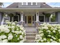 Inviting front porch with charming details and lush hydrangea, perfect for relaxing outdoors at 4813 E 11Th St, Indianapolis, IN 46201