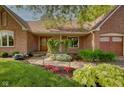 Beautiful brick home with meticulous landscaping and inviting walkway to the front door at 5037 Surrey Ln, Carmel, IN 46033