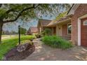 Lovely home with mature trees, a well-kept lawn, and a brick exterior at 5037 Surrey Ln, Carmel, IN 46033