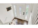 Bright foyer with a white front door with decorative glass panels and wood flooring at 586 Shady Creek Dr, Greenwood, IN 46142