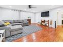 Inviting living room featuring hardwood floors, a comfortable gray sectional, and stylish decor at 624 10Th St, Chesterfield, IN 46017