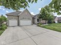 Beautiful brick home with a large driveway and well-maintained landscaping at 6525 Carolina Blvd, Indianapolis, IN 46217