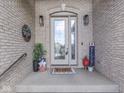 Welcoming front entrance with a decorated porch, charming décor and glass paneled door at 6525 Carolina Blvd, Indianapolis, IN 46217