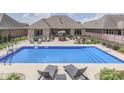 Inviting backyard with a sparkling in-ground pool, lounge chairs, and an outdoor dining area at 6525 Carolina Blvd, Indianapolis, IN 46217