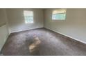 Bright bedroom featuring neutral walls, carpeted floors, and two windows for ample natural light at 667 E Edgewood Ave, Indianapolis, IN 46227