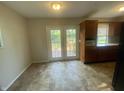Bright dining area with access to the deck and featuring tile floors and ample cabinet space at 667 E Edgewood Ave, Indianapolis, IN 46227