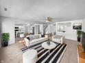 Bright living room with modern furnishings, neutral tones, and a view into the kitchen at 7854 Wolfgang Pl, Indianapolis, IN 46239