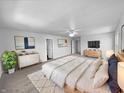 Spacious main bedroom featuring neutral carpet, ceiling fan and ample natural light at 7854 Wolfgang Pl, Indianapolis, IN 46239