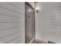 Neutral door entrance with overhead lighting, dark hardware, and a modern design at 8176 Shorewalk Dr # C, Indianapolis, IN 46236