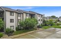 Condo exterior featuring ample parking, mature landscaping, and a well-maintained facade at 8176 Shorewalk Dr # C, Indianapolis, IN 46236