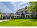 Charming exterior view of a two-story home with a well-manicured lawn and a three-car garage with basketball hoop at 10974 Harbor Bay Dr, Fishers, IN 46040