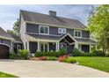 Stunning exterior view of a two-story home featuring a cozy front porch and beautiful landscaping at 10974 Harbor Bay Dr, Fishers, IN 46040