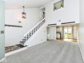 Inviting living room with stairs, an open layout, neutral carpeting, and easy access to the kitchen at 1124 Paradise Ct # B, Greenwood, IN 46143