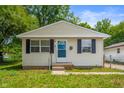 Charming single-story home with neutral siding, dark shutters, and a well-maintained lawn and landscaping at 1141 Madeira St, Indianapolis, IN 46203