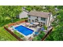 Aerial view of a backyard oasis with a sparkling pool, patio area, and a well-maintained wooden fence at 12043 Searay Dr, Indianapolis, IN 46236