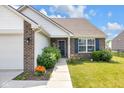 Inviting home exterior with a manicured walkway leading to a welcoming front door at 12105 Fall Ct, Indianapolis, IN 46229