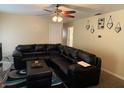 Comfortable living room with neutral walls, carpet, ceiling fan and a large sectional couch for relaxing at 1308 Phillips Dr, Indianapolis, IN 46241