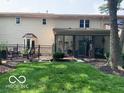 Spacious backyard with a black metal fence and an outdoor patio seating area at 1419 Dominion Dr, Zionsville, IN 46077