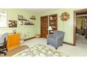 This bedroom features soothing green walls, built-in shelves, and a comfortable reading nook at 1497 N 200 W, Greenfield, IN 46140