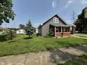 Charming gray home with a cozy front porch, brick accents, and well-manicured lawn at 1501 California St, Columbus, IN 47201