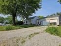 Single-story home with a detached two-car garage and a driveway leading to the home at 1510 Chester St, Anderson, IN 46012