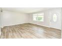 Bright, open living room with hardwood floors, large windows, and a freshly painted interior at 1543 W 79Th St, Indianapolis, IN 46260