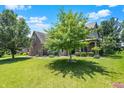 Attractive two-story home with brick and siding exterior, surrounded by a green lawn and mature trees at 1808 Woodfield Dr, Greenwood, IN 46143
