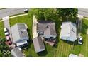 Aerial shot of the home with a deck, showing its location among neighboring houses and green yards at 1837 Bauer Rd, Indianapolis, IN 46218