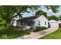 Lovely one-story home with a detached garage, offering curb appeal and a well-manicured yard at 1837 Bauer Rd, Indianapolis, IN 46218