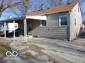 Rear exterior view featuring a covered parking area and access to the home at 2250 N Goodlet Ave, Indianapolis, IN 46222