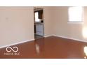Bright living room with hardwood floors and a view into the kitchen area at 2250 N Goodlet Ave, Indianapolis, IN 46222
