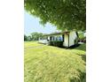 Well maintained house with a lush green lawn and mature trees at 3103 Keswick Rd, Indianapolis, IN 46222