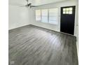 Bright living room with hardwood floors and a large window at 3103 Keswick Rd, Indianapolis, IN 46222