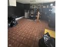 Unfinished basement space with patterned tile flooring and storage shelving at 3570 Decamp Dr, Indianapolis, IN 46226