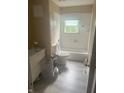 Bathroom featuring a tub with shower, toilet, window, and neutral colors at 3570 Decamp Dr, Indianapolis, IN 46226